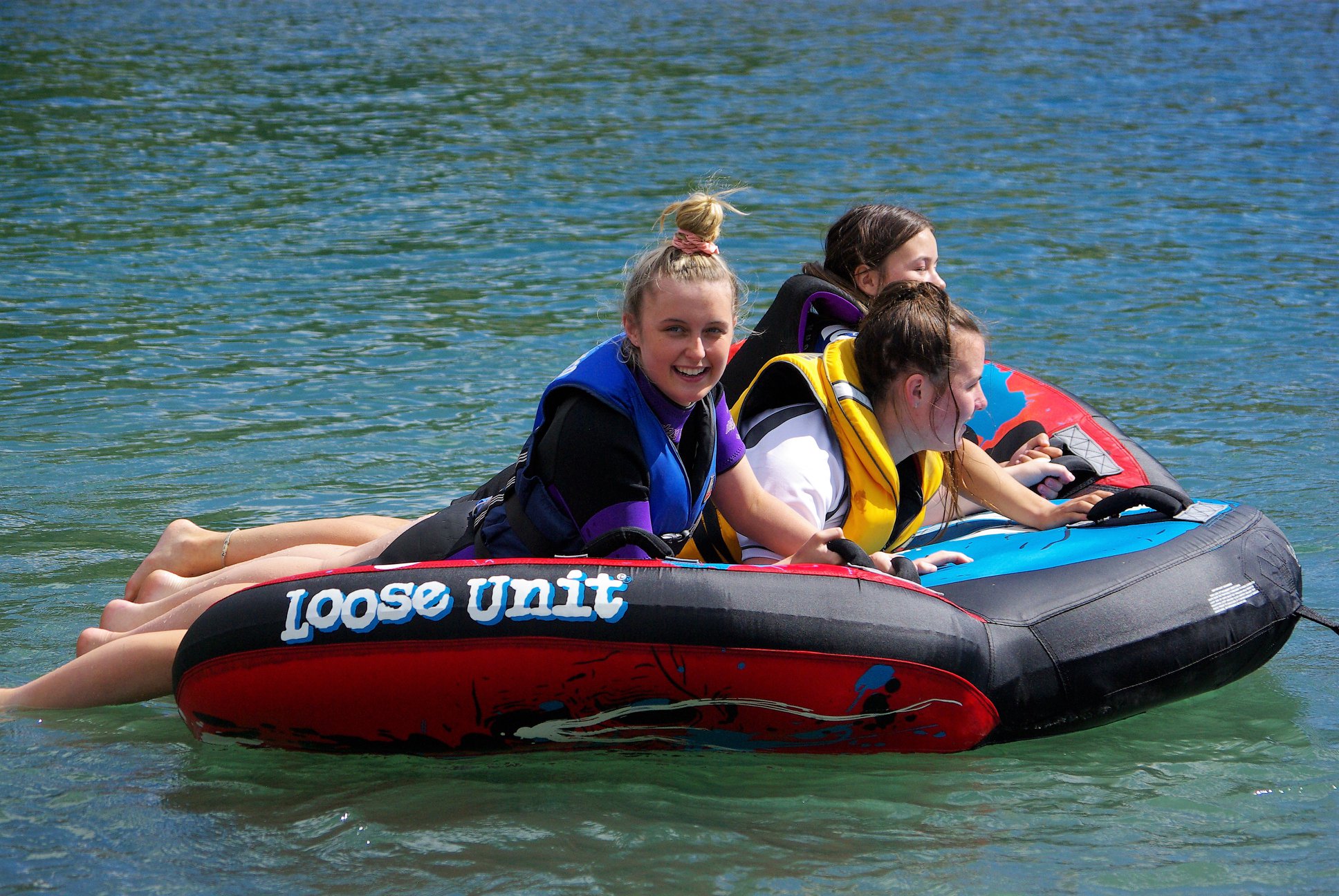 Waitaki Girls High students floating on large tubes in a lake